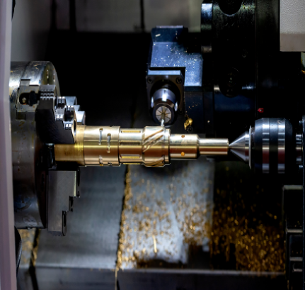 Precision lathe turning a brass shaft component